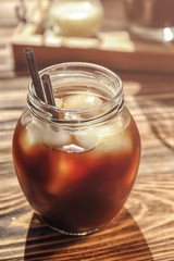 Jar with cold brew coffee on wooden table