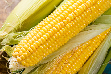 Fresh corn on rustic wooden table, closeup