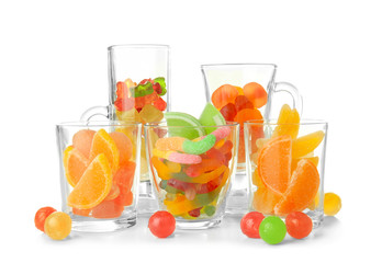 Colorful candies in glasses on white background