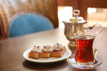 Turkish tea in traditional glass on wooden table