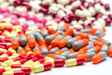 Colorful of antibiotic capsules pills on white background, drug resistance