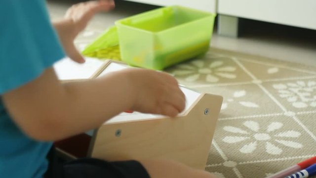 Little cute boy playing at home with cashbox