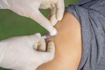 doctor giving a vaccine for a patient