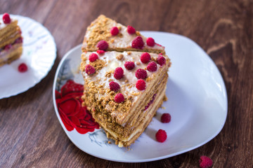 Homemade cake baking on a platter on a wooden background.