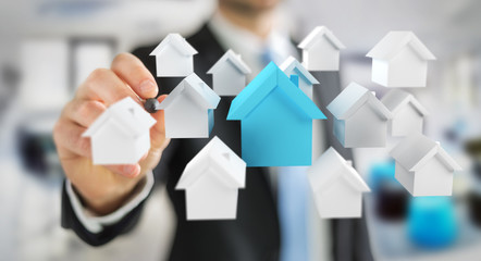 Businessman using 3D rendered small white and blue houses