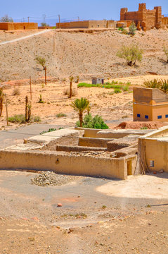 small village in a desert part of Morocco, mud houses of bright saturated color