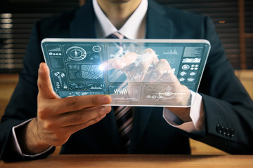 businessperson holding futuristic information device. graphical user interface(GUI). internet of...