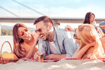 Happy friends partying on the beach