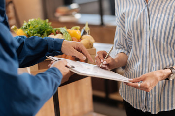 Smart nice woman putting her signature