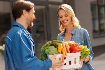 Cheerful friendly woman picking up her groceries