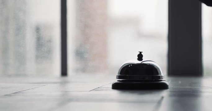 Modern Luxury Hotel Reception Counter Desk With Bell - Hand Strikes The Bell On Hotel Reception