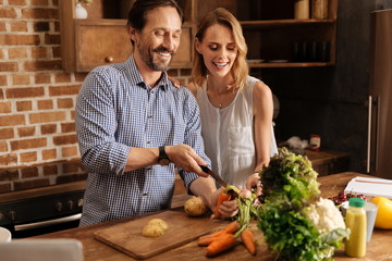 Original lively man peeling carrots