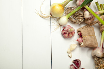 Fresh garlic and onion on white background