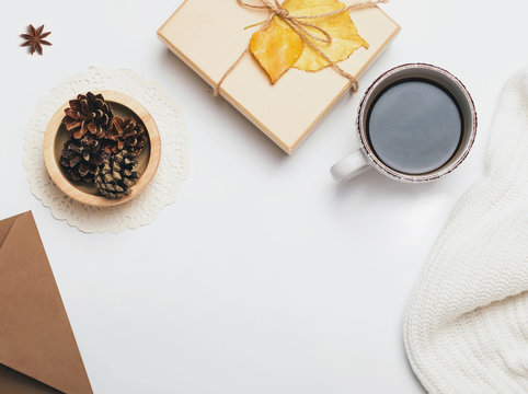 Coffee, sweater, pine cones and giftbox decorated with yellow leave