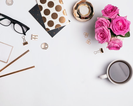 Woman's Workplace With Gold Accessories, Coffee And Beautiful Roses