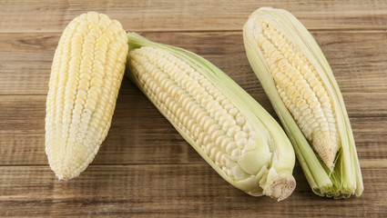 Cob of corn on a wooden background