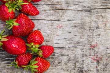 Ripe fresh strawberries on rustic wooden background with copy space. Top view