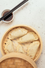 Handmade Dim Sum with Soja sauce in a Bamboo Container