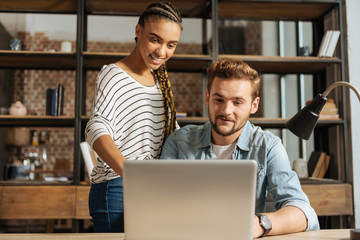 Attractive girl helping her boyfriend