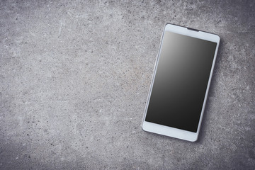 Smart phone on gray stone background