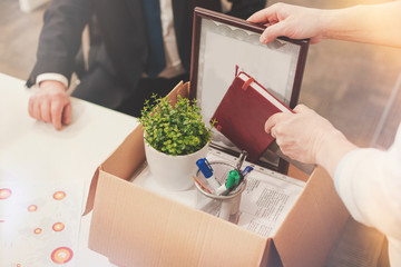 Precise neat man packing all his documents in a box
