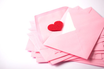 close up Stacking of pink envelopes and mail letter paper and the red herat , romance  love letter concept for holiday valentines day greeting card concept