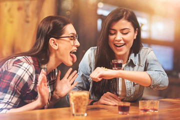 Joyful girls making faces while enjoying Friday evening