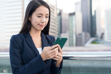 Business woman using cellphone on the city