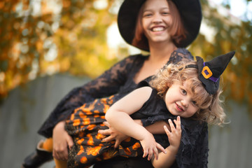 Mother and child dressed like witches, having fun