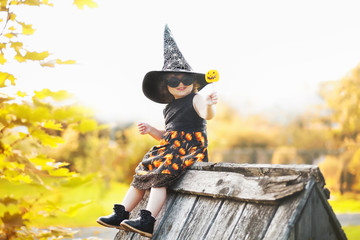 Little girl witch sitting on a roof