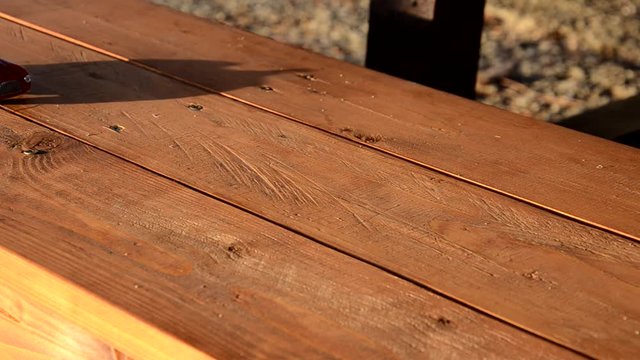 Toy car travels on a wooden bench