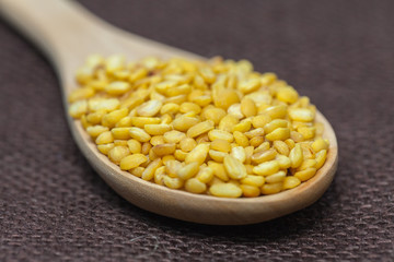 peeled mung beans on wood spoon