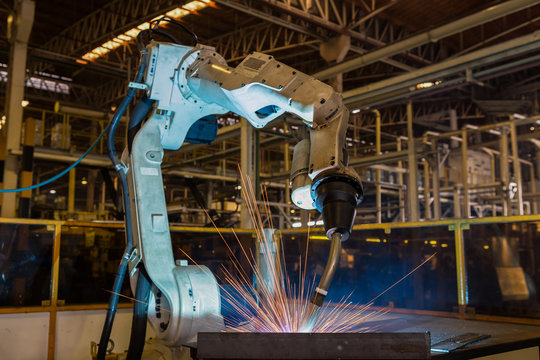 Industrial robot is welding in automotive part factory