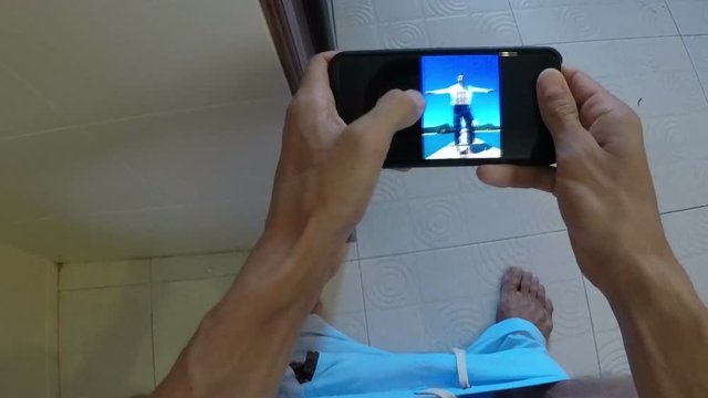 POV Of Man Sitting On Toilet Watching Photos While Angry Girl Open Door Taking Away Cell Smart Phone From Restroom