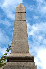 Obraz premium granite stela on a background of blue sky