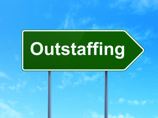 Finance concept: Outstaffing on road sign background