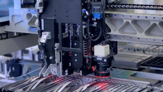 Modern robotic machine manufacturing PCBs. 4K.