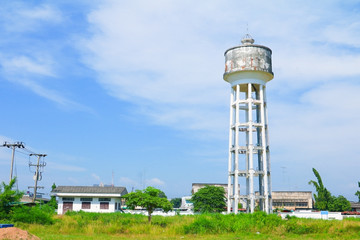 water tank tower old for agriculture and landscape.city meadow tree on blue sky background with copy space add text