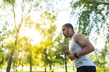 Naklejka na ściany i meble african american sportsman running in park