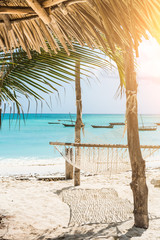 beautiful colorful seascape with hammock and palm on a beach