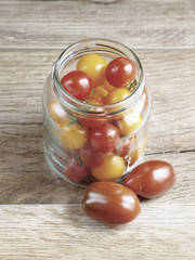 Cherry tomatoes background in a glass jar