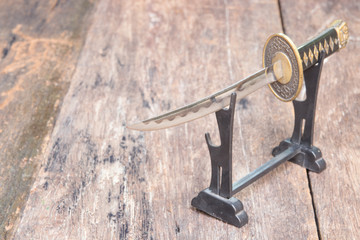 sword steel blade samurai and scabbard easel ancient on old wooden surface floor with copy space