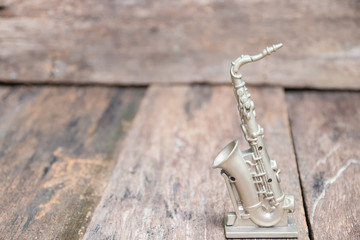 saxophone for decorate old on vintage wooden background with copy space add text