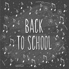 Fototapeta na wymiar Back to school. Hand drawn lettering and doodle chalk music elements on classroom chalkboard