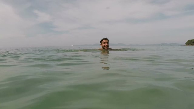 Hispanic Man Swimming In Sea Water Action Camera POV Of Young Guy On Beautiful Beach During Summer Vacation