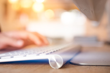Business economic and technology working concept. Close up woman hand using keyboard and personal computer in coffee shop.