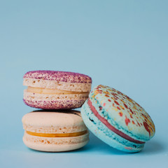 Different types of macaroons on a blue background