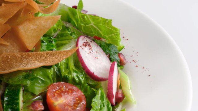 Levantine salad Fattoush, made from toasted or fried pieces of Arabic flat bread, mixed with vegetables, loop, 4K, ProRes codec, 422 HQ, ISO 100