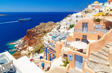 Greece Santorini island in Cyclades, traditional sights of colorful and white washed walk paths like narrow streets and caldera sea in background - obrazy, fototapety, plakaty
