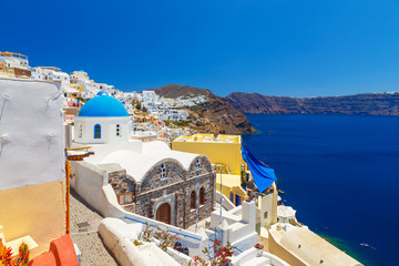 Greece Santorini island in Cyclades, traditional sights of colorful and white washed walk paths like narrow streets and caldera sea in background